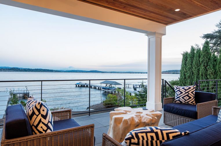 The covered porch was rebuilt and the owners enjoy the views in Restoration Hardware furniture.