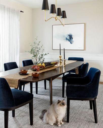 The dining room has a Room & Board table surrounded by Restoration Hardware chairs, and artwork by Kippi Leonard via Seattle Art Source.