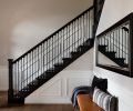 Stefanie and Lars Gouwerok’s Seattle home speaks to their style after a remodel led by interior designer Brooke Prince of the White Space Design Group. In the entry, a Bocci chandelier is suspended over a refreshed staircase and CB2 bench with Susan O’Conner pillows.