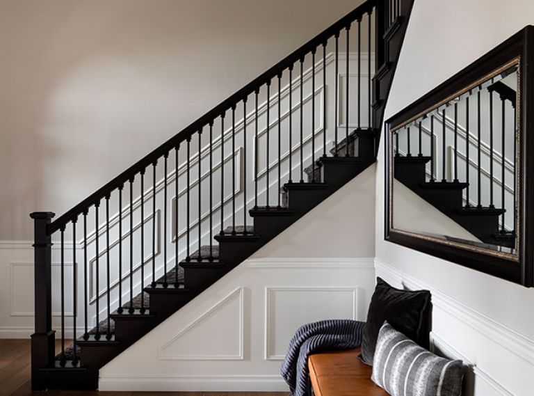 Stefanie and Lars Gouwerok’s Seattle home speaks to their style after a remodel led by interior designer Brooke Prince of the White Space Design Group. In the entry, a Bocci chandelier is suspended over a refreshed staircase and CB2 bench with Susan O’Conner pillows.