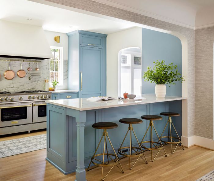 The homeowners had always wanted a blue kitchen. The dusty robin’s egg blue, a custom color from Benjamin Moore, compliments the orange stucco exterior of the house visible from several views. “It’s cheerful enough that it won’t blend into Portland’s often gray skies, but it has enough gray that it doesn’t feel like a color-crayon version,” says designer Charla Ray.