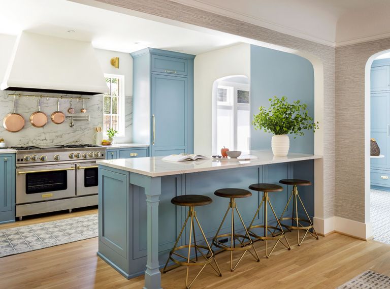 The homeowners had always wanted a blue kitchen. The dusty robin’s egg blue, a custom color from Benjamin Moore, compliments the orange stucco exterior of the house visible from several views. “It’s cheerful enough that it won’t blend into Portland’s often gray skies, but it has enough gray that it doesn’t feel like a color-crayon version,” says designer Charla Ray.