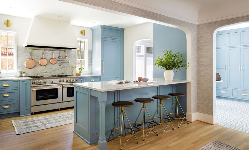 The homeowners had always wanted a blue kitchen. The dusty robin’s egg blue, a custom color from Benjamin Moore, compliments the orange stucco exterior of the house visible from several views. “It’s cheerful enough that it won’t blend into Portland’s often gray skies, but it has enough gray that it doesn’t feel like a color-crayon version,” says designer Charla Ray.