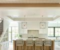 Atelier Drome designed kitchen layout with warm wood accents in beams and island. Tray ceiling with shiplap and crown molding painted Benjamin Moore Chantilly Lace. Hudson Valley metal caged lighting with farmhouse flare. Cabinetry built by Amish carpenters in Ohio. Pella windows.