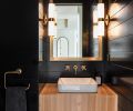 Dramatically designed Powder Room was Alison’s nod to 10 years of New York City living. She calls it, “A dark, moody, dramatic hotel type experience.” Real wood Tricorn Black Sherwin Williams painted paneling, flattering Restoration Hardware lighting. Solid Slab White Oak sink mount custom Amish-built design by Dacoda Homes.