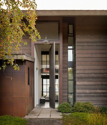 A motorized hopper window creates a substantial cross breeze when opened with pivot door below and glass Dutch door beyond.