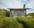 Steel cladding is 16-gauge hot rolled steel. Siding is shiplap spruce wood. Moveable shutters are spruce on steel framing.