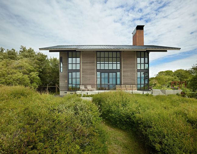 Steel cladding is 16-gauge hot rolled steel. Siding is shiplap spruce wood. Moveable shutters are spruce on steel framing.