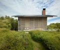 View of horizontal spruce shutters closed against sun and elements.