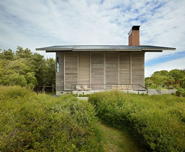 View of horizontal spruce shutters closed against sun and elements.