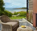 Low tide in False Bay toward Haro Strait and the Olympic Mountains. Existing driftwood bench. A masonry fireplace is overlayed with hot rolled steel that has weathered in the elements.