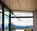 A 25-foot island anchors the kitchen and dining room. Pocketed sliding glass doors by Fleetwood frame the distant views and connect to the rear deck.