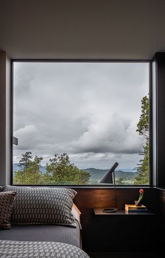 An AJ by Louis Paulsen lamp illuminates the downstairs bedroom.