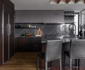 Kitchen features painted Sapele African hardwood upper cabinets by Sky River Industries. Thin Line Sonneman light fixture task lighting. Espresso-stained lower cabinets play off Hallmark Alta Vista Malibu wooden floors from CFM. Crate & Barrel leather stools.