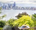 Japanese Forest Grass spills over planters, contrasting with curved glass birdbath. Photography © Doreen L. Wynja