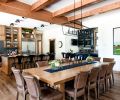 White Label Interiors custom designed the dining table, made by Winterwood Cabinets. The Four Hands dining chairs are from J Garner Home, and the iron light fixture overhead is Miseno.