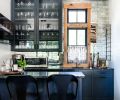 Tucked in an alcove off the kitchen, the bar has more dramatic finishes, like the antiqued mirror tile, “Dutchess” by Bedrosians, and cabinetry painted Benjamin Moore “Midnight Blue.”