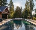 The sleek pool was designed with a ledge so vacationers can sit in the water without submerging. The pool house provides a spot for kids to play, an extra bedroom, or a nearby drinks station.