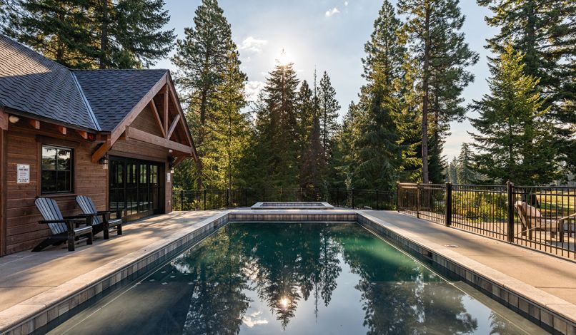 The sleek pool was designed with a ledge so vacationers can sit in the water without submerging. The pool house provides a spot for kids to play, an extra bedroom, or a nearby drinks station.