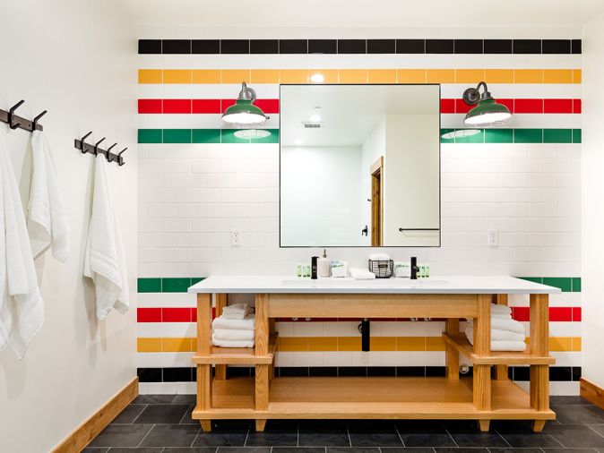 In a cheeky nod to tradition, Becker took inspiration from a Glacier Bay blanket for the kids’ bathroom, featuring multi-colored striped wall tile and black slate floor tile from Bedrosians. White Label Interiors custom-designed the vanity.
