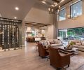 O’Brien’s custom wine cellar is a focal point upon entry to the home. The homeowners enjoy in equal parts collecting and sharing wine. Locating the cellar here invites guests to explore and share in the collection. The temperature-controlled space has vertical wine racks that float in front of a textured plaster wall to create depth and interest. The glass is affixed with black metal accents, and recessed light fixtures highlight the wine bottles.