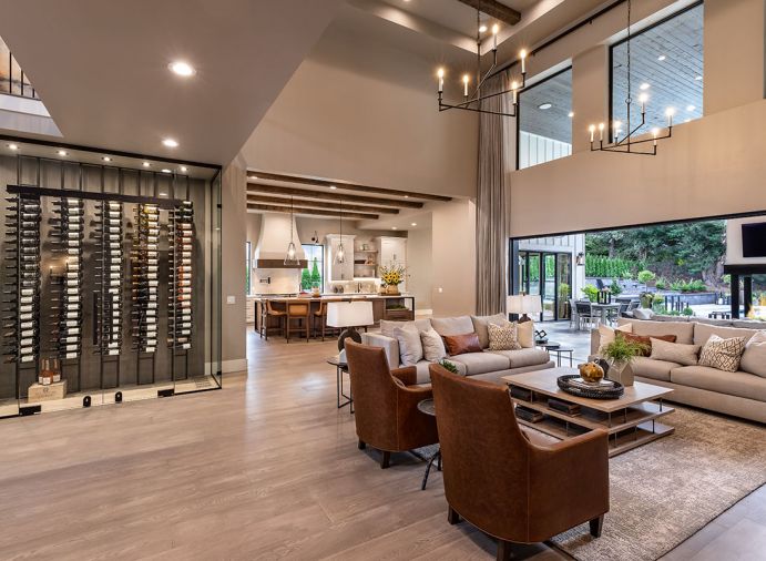 O’Brien’s custom wine cellar is a focal point upon entry to the home. The homeowners enjoy in equal parts collecting and sharing wine. Locating the cellar here invites guests to explore and share in the collection. The temperature-controlled space has vertical wine racks that float in front of a textured plaster wall to create depth and interest. The glass is affixed with black metal accents, and recessed light fixtures highlight the wine bottles.