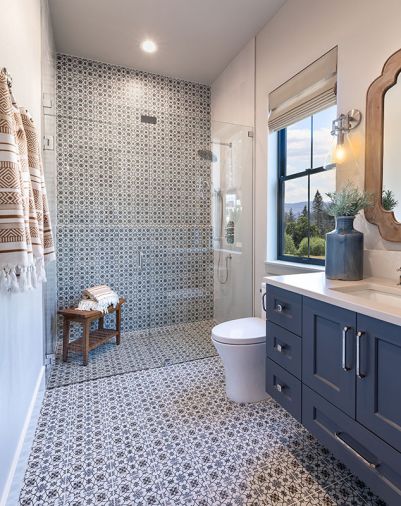 The guest bath’s swath of Italian tile is a traditional pattern but done boldly and dynamically, flowing from ceiling to wall. In both spaces, O’Brien always looks to balance straight and curved lines. Entering both these rooms evokes a feeling of vacationing in your own home.