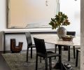 In the dining room, the painting “Long Beach” by Michael Dailey sits above a whitewashed-poplar and blackened-steel console from Chadhaus. The Eero Saarinen Tulip Table is surrounded by Cassina Cab chairs from Inform Interiors, atop a rug from Driscoll Robbins. “It was important to me that the rug corresponded to the dark floor,” says Hellstern.