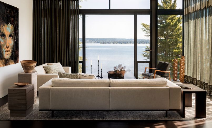 In the living room, two Piet Boon couches from Inform Interiors are flanked by Piet Boon marble side tables on one side, and a custom “Via” side table designed by Charlie Hellstern for the ‘Loom Collection’ and built by Stusser Woodworks Inc. The large-scale painting is by Tony Scherman, and Aleph Geddis carved the wood sculptures in the corner.