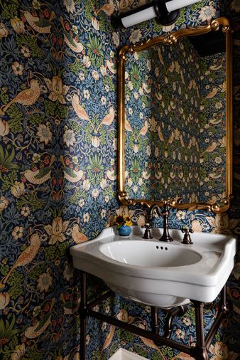  Rowland added a powder bath and ensconced the walls in Morris & Co wallpaper, from Kelly Forslund at the Seattle Design Center. A Signature Hardware sink and faucet, are joined by a Cooper Classics mirror and Visual Comfort sconce.
