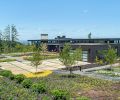 This 4,500-square-foot home on 40 acres in the Chehalem Mountains was completed in 2020 by Scott Edwards Architecture and iBuildPdx, for owners who wanted to celebrate the site, make art, and retreat from city life. Its stunning views of several mountains earned its name as the Five Peaks Lookout. The landscape design was led by Shapiro/Didway, who created a modern, geometric entry court in front that leads to an orange Fleetwood door. The exterior siding is from Lakeside Lumber. Photography © Peter Eckert