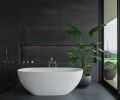 A soaking tub from Badeloft USA sits against floor and wall tile by Fiandre. “It’s a large scale, almost black tile that has a painterly movement to the surface,” says Cruse. “I didn’t want flat colors. Everything has some muddiness to it, so it feels more alive.” Photography © Peter Eckert