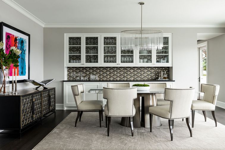 From Seattle Design Center: Regency style John Pomp sideboard from Trammel Gagne ties to Carlisle Wallcovering on credenza from Jennifer West. Arteriors oval glass crystal chandelier echoes Powell & Donnell table base. Silk starburst Turabi rug pattern radiates from center of table.