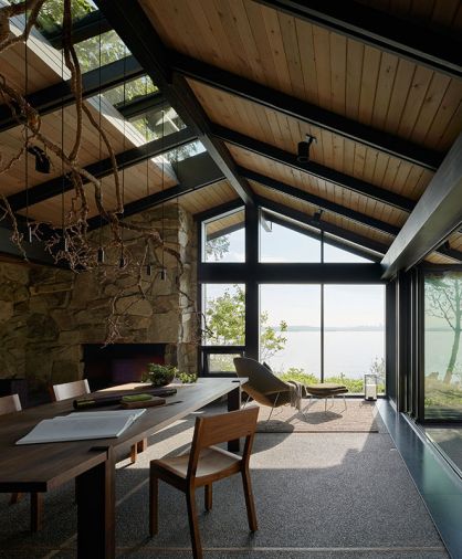 Conference room in north house doubles as guest room. Stefan Gulassa transformed a salvaged wisteria branch from dilapidated deck into chandelier. Sawkille Co. table. Chadhaus Studio Chairs. Insulated original roof and skylights above. Photography © Kevin Scott