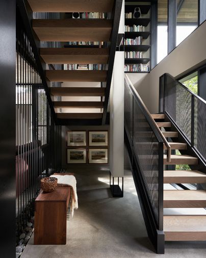 Chadhaus bench crafted from Pacific Northwest Walnut. Steel curtain’s tensioning vessels are located beneath family-collected rocks found on property in recessed area of floor. Photography © Kevin Scott