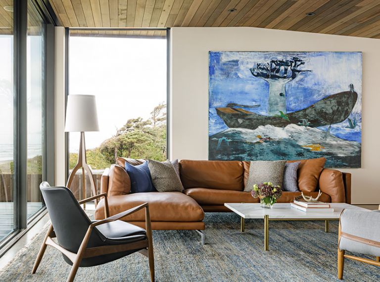 In the living room, Freres combined an Italian leather sofa and a Seal Chair, both from Design Within Reach, with a custom Calacatta marble-and-brass coffee table, atop a Wool Loloi rug. The vibrant painting is “Leaving Madagascar” by Paton Miller from Butters Gallery. “I saw this piece and it sort-of took my breath away,” says Freres. “It brings so much story and conversation.”