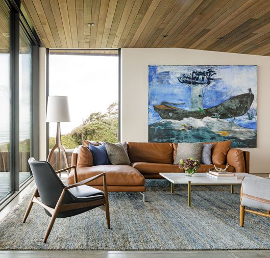 In the living room, Freres combined an Italian leather sofa and a Seal Chair, both from Design Within Reach, with a custom Calacatta marble-and-brass coffee table, atop a Wool Loloi rug. The vibrant painting is “Leaving Madagascar” by Paton Miller from Butters Gallery. “I saw this piece and it sort-of took my breath away,” says Freres. “It brings so much story and conversation.”