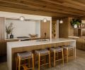 “This is my favorite kitchen to work in because it’s so open,” says Kari. “And so many people can work around the big island.” It’s wrapped in PentalQuartz, with a Blanco sink and Kallista faucet, from Ferguson. The stove niche sports the same stone, with a Wolf cooktop and Vent-A-Hood extractor above.