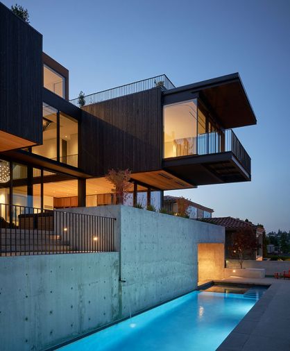 Custom steel railings enclose the roof deck, crowning cantilevered primary bedroom with custom profile T&G cedar siding rainscreen with ebony stain. After Alpine Welding assembled the cantilevered pieces, they craned them up and spent four days welding the freezing steel into place during a February cold snap. Sapele wood clad aluminum windows. Infratech outdoor heaters.