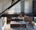 A suspended staircase to roof deck and gardens features double smoked oak engineered wood floors, perforated stairs, and steel guardrail.