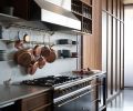 Vent-A-Hood draws eye to Sarah’s must-have Lacanche range that adds antique flare to kitchen’s modern design while artfully pairing with a cache of copper pots on pot rails against Carrera Marble backsplash. True wine fridge assists meal prep.