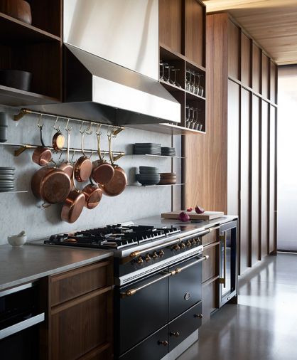 Vent-A-Hood draws eye to Sarah’s must-have Lacanche range that adds antique flare to kitchen’s modern design while artfully pairing with a cache of copper pots on pot rails against Carrera Marble backsplash. True wine fridge assists meal prep.
