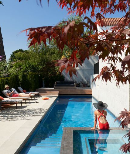 Custom stainless steel weir cascades water into pool. “To create the effect of the concrete site wall “diving” into pool required sequencing of various trades to make it happen,” says Thomas.