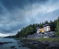 Kristi Linsenmayer selected architects Dan Wickline and Brian Watzin of Prentiss + Balance + Wickline, alongside interior designer Emily Knudsen and Marble Construction, to help create her home in Ketchikan, Alaska. It cantilevers over the edge of its site to make the most of the surroundings. The shiplap cedar on the exterior of the home was milled locally and finished with Benjamin Moore Arborcoat, in black, while wraparound Koble VistaLuxe Windows further connect the interior to the outdoors.