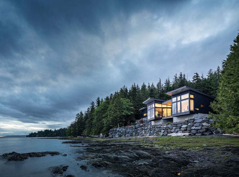 Kristi Linsenmayer selected architects Dan Wickline and Brian Watzin of Prentiss + Balance + Wickline, alongside interior designer Emily Knudsen and Marble Construction, to help create her home in Ketchikan, Alaska. It cantilevers over the edge of its site to make the most of the surroundings. The shiplap cedar on the exterior of the home was milled locally and finished with Benjamin Moore Arborcoat, in black, while wraparound Koble VistaLuxe Windows further connect the interior to the outdoors.