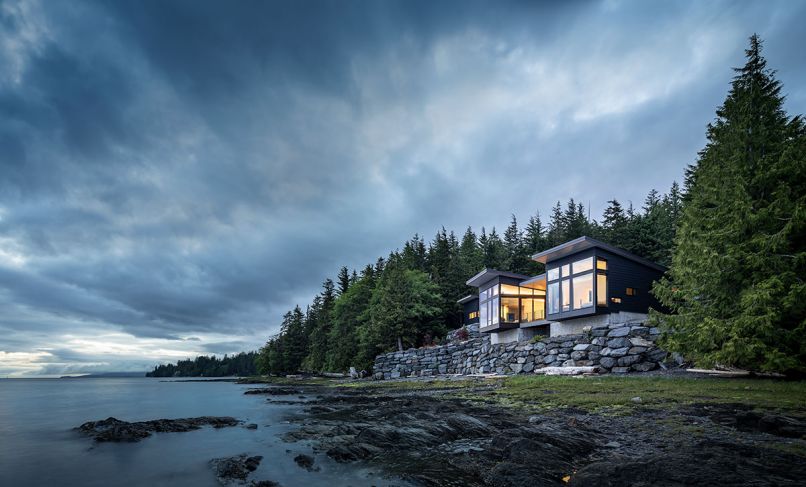 Kristi Linsenmayer selected architects Dan Wickline and Brian Watzin of Prentiss + Balance + Wickline, alongside interior designer Emily Knudsen and Marble Construction, to help create her home in Ketchikan, Alaska. It cantilevers over the edge of its site to make the most of the surroundings. The shiplap cedar on the exterior of the home was milled locally and finished with Benjamin Moore Arborcoat, in black, while wraparound Koble VistaLuxe Windows further connect the interior to the outdoors.