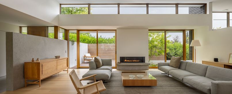 Cherry Creek Windows & Doors supplied Marvin Ultimate windows and doors. Spark Modern Fires fireplace. Soft Dream sofa and chaise by Flex Form flank Bensen wood coffee table. De La Espada sideboard left. Cantilevered sideboard right. Benjamin Moore Winter White throughout.