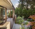 At back of house another deck featuring Ipe deck material, custom sliding cedar screen. Cherry Creek Windows & Doors Marvin sliding glass door leads to living room. Studio Tolvanen Terassi lounge chairs with outdoor cushions.