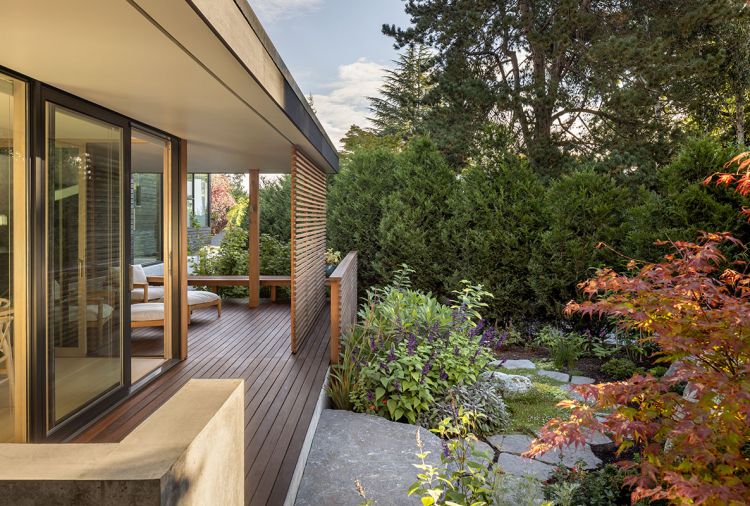 At back of house another deck featuring Ipe deck material, custom sliding cedar screen. Cherry Creek Windows & Doors Marvin sliding glass door leads to living room. Studio Tolvanen Terassi lounge chairs with outdoor cushions.