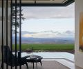 Main Level sitting room view of rolling hills/wine country through Andersen/Weiland pocket doors from Portland Millwork. Vertical screens frame Gorini Divani chair and Mobital side table.